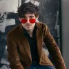 A man in a brown jacket and red-lensed sunglasses